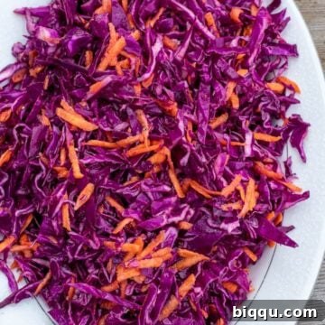 red cabbage slaw on a platter, garnished beautifully