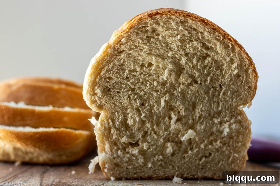 Perfect Everyday Sandwich Bread 9 Half a loaf of homemade bread with bread slices on the side