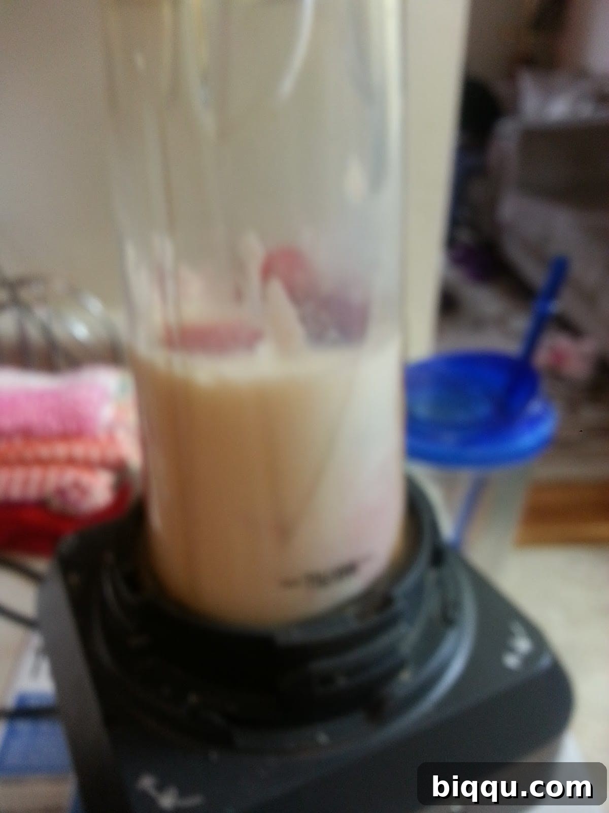 Blender with strawberry, yogurt, milk, and honey mixture