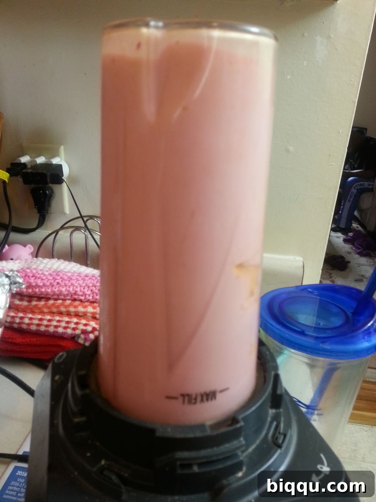 Blended smooth strawberry yogurt mixture in a blender