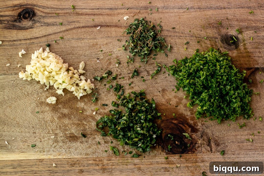 Golden Oven Grilled Whole Red Snapper 5 Minced fresh herbs and garlic neatly arranged on a chopping board, ready for the marinade