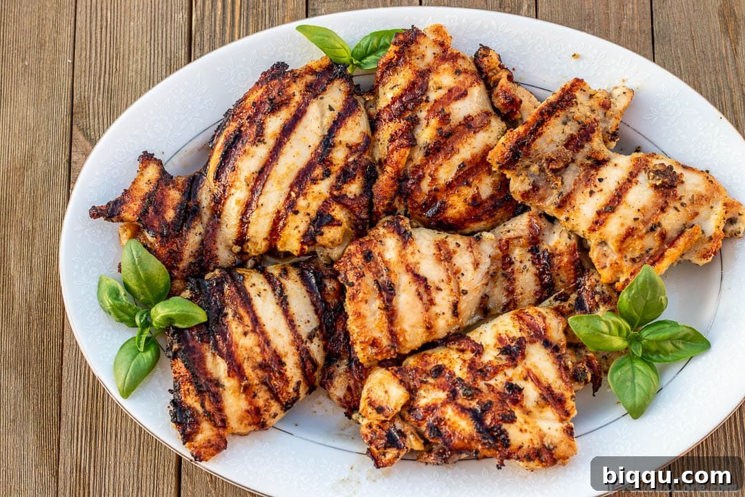 Succulent Grilled Boneless Chicken Thighs 6 Platter of perfectly grilled chicken thighs with distinct grill marks, ready to serve