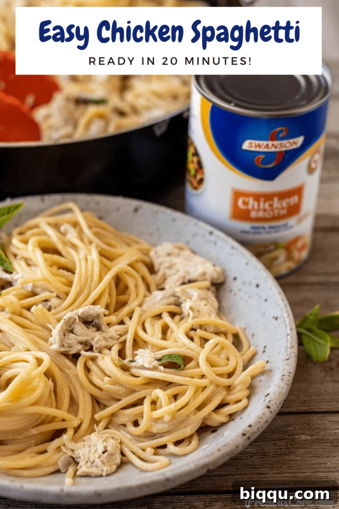 Chicken spaghetti in a bowl with a fork, showing creamy texture.