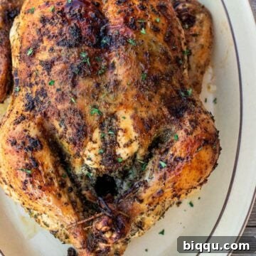 Whole herb roasted chicken on a platter