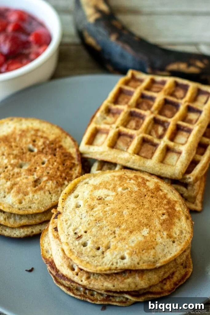 A vibrant platter showcasing golden plantain pancakes and crispy plantain waffles, garnished with fresh berries and a drizzle of maple syrup.