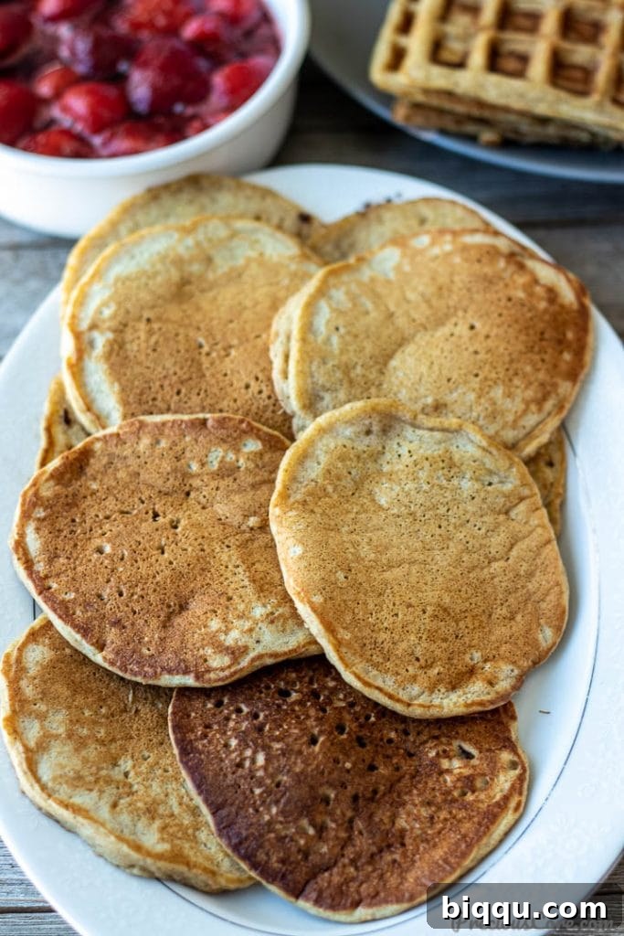 A stack of golden brown plantain pancakes resting on a pristine white platter, ready to be served and enjoyed.