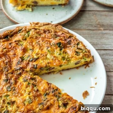 Easy Quiche on a white plate, showcasing its delicious appeal.