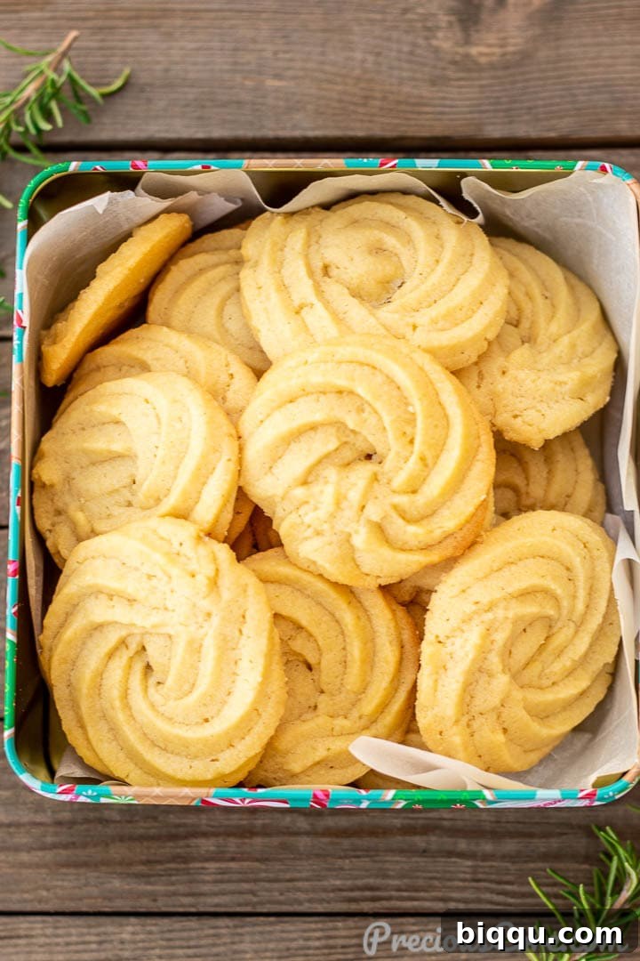 Danish Butter Cookies neatly stacked inside a decorative cookie tin, ready for gifting or storage.