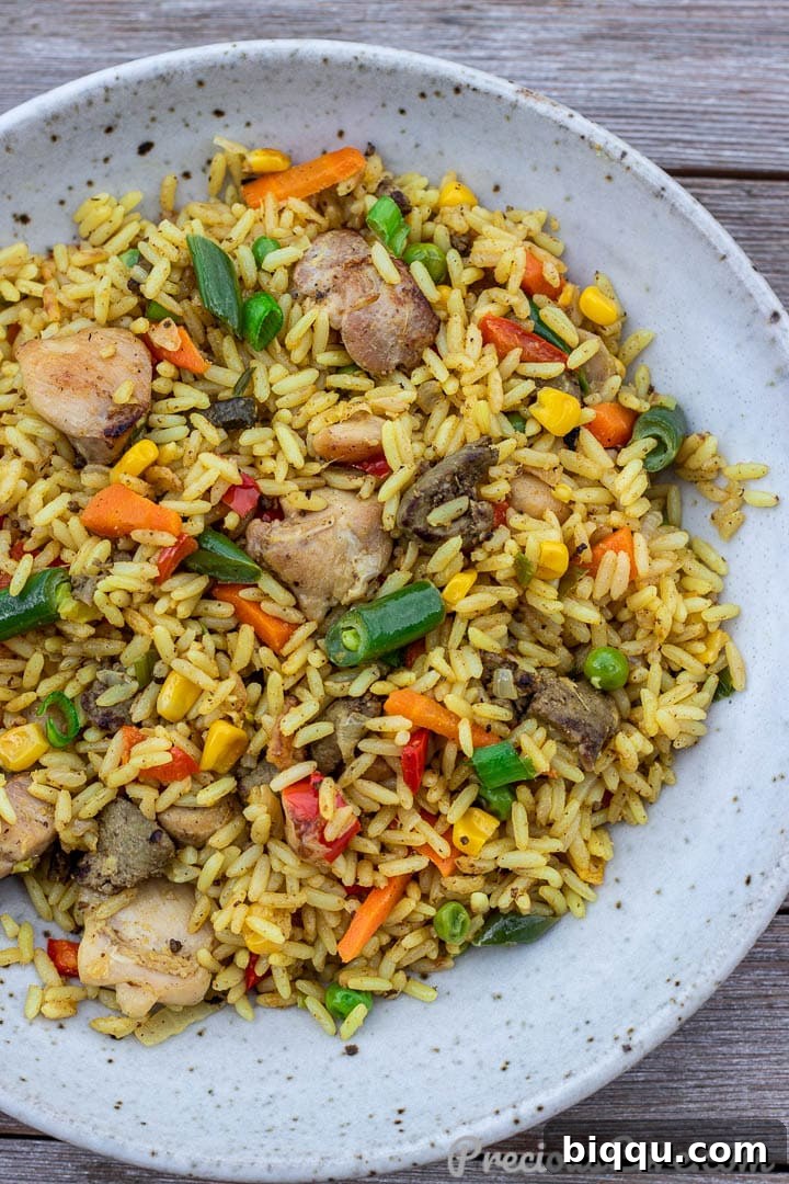 A bowl of freshly cooked African Fried Rice, garnished and ready to eat