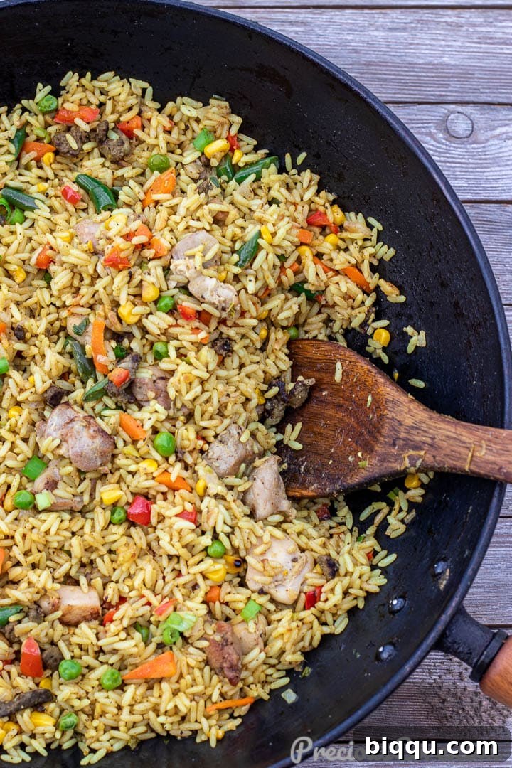Close-up view of Chicken Fried Rice being stir-fried in a wok