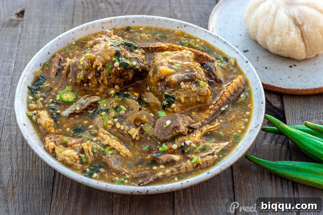 A beautifully presented landscape shot of African Okra Soup, accompanied by a perfectly molded fufu, symbolizing a traditional meal