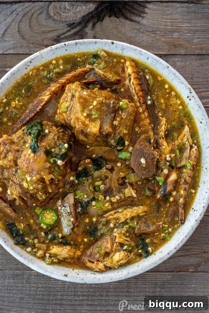 A close-up of a steaming bowl of African Okra Soup, showcasing its vibrant color and tempting textures.