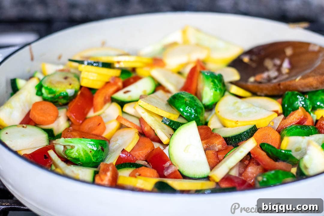 Vibrant Veggie Sauté 7 All assorted vegetables combined in the pan, actively sautéing and browning