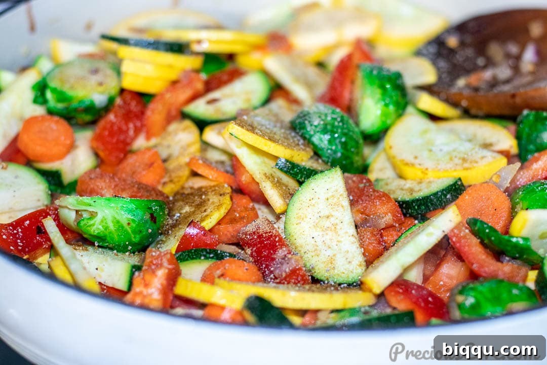 Vibrant Veggie Sauté 8 Sautéed vegetables with seasoning freshly sprinkled on top, ready to be tossed for final flavor integration