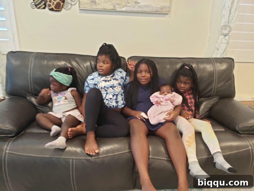 Five girls sitting on couch.