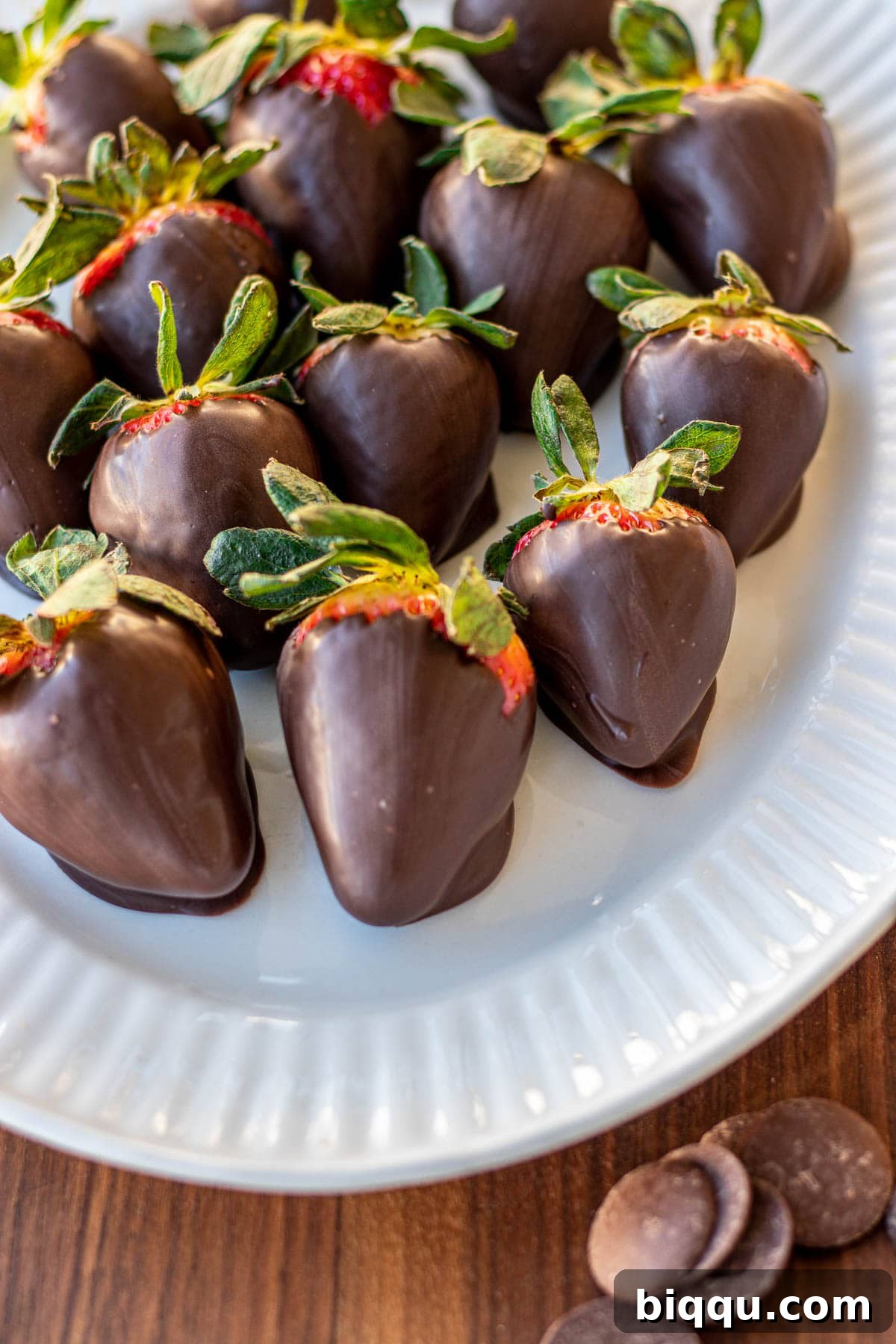 Close-up of freshly dipped dark chocolate covered strawberries, perfectly set and glistening, ready for serving.