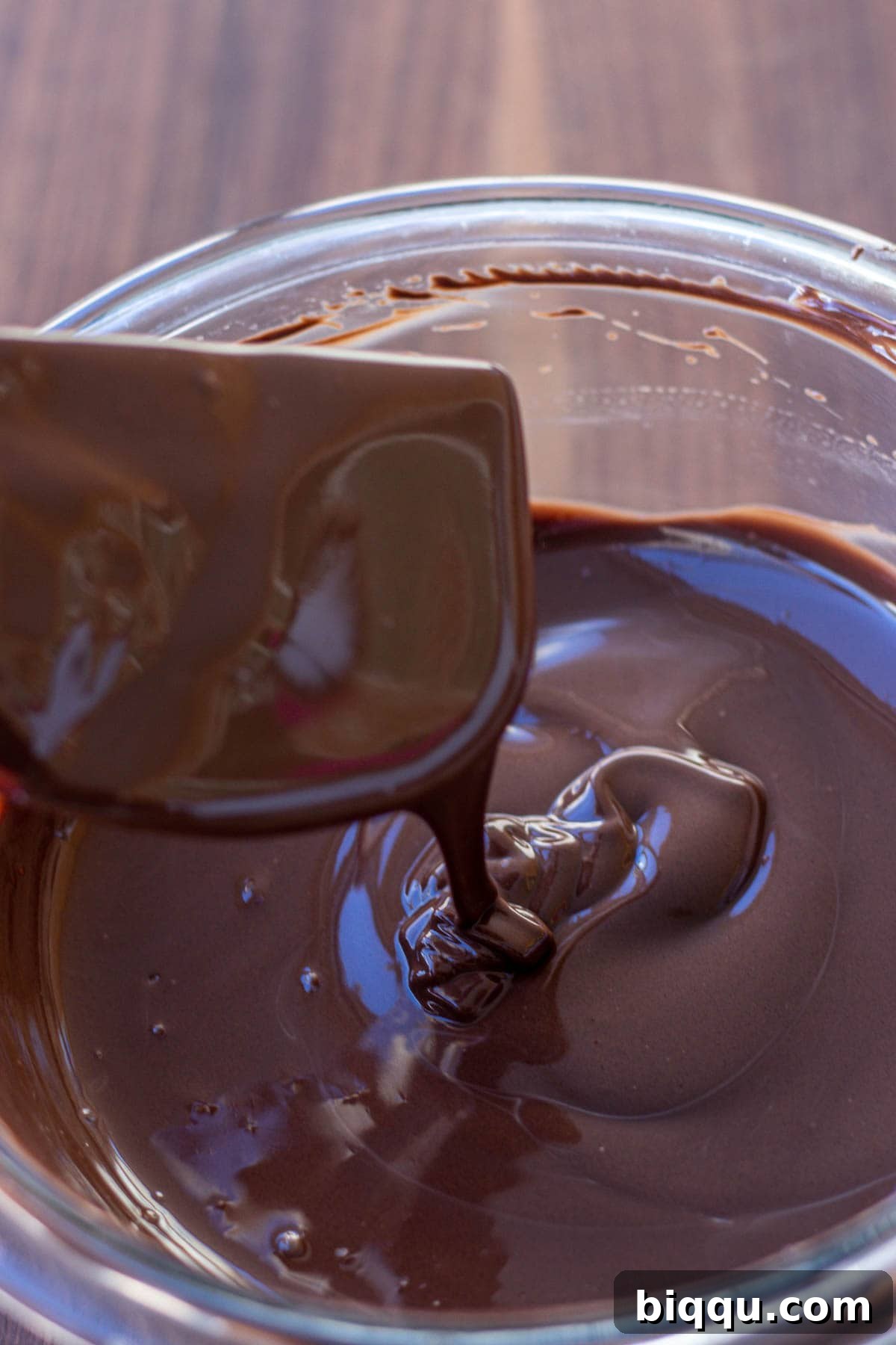 Close-up of perfectly melted chocolate, showcasing its smooth, glossy texture and readiness for dipping.