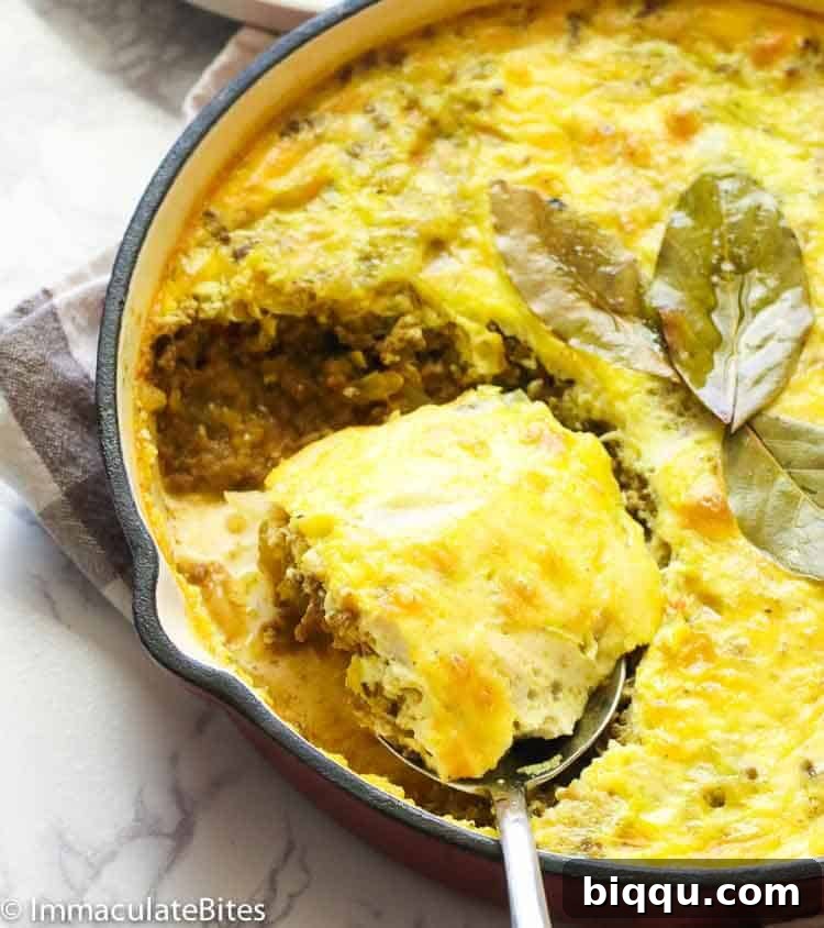 A cast iron pot of South African Bobotie, a comforting baked dish.