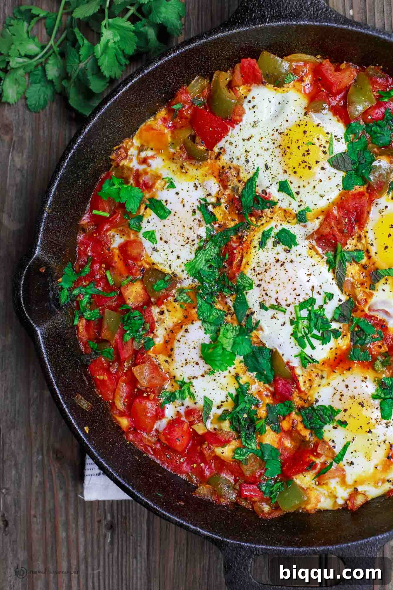 Shakshuka in a cast iron skillet, a delicious North African vegetarian meal.