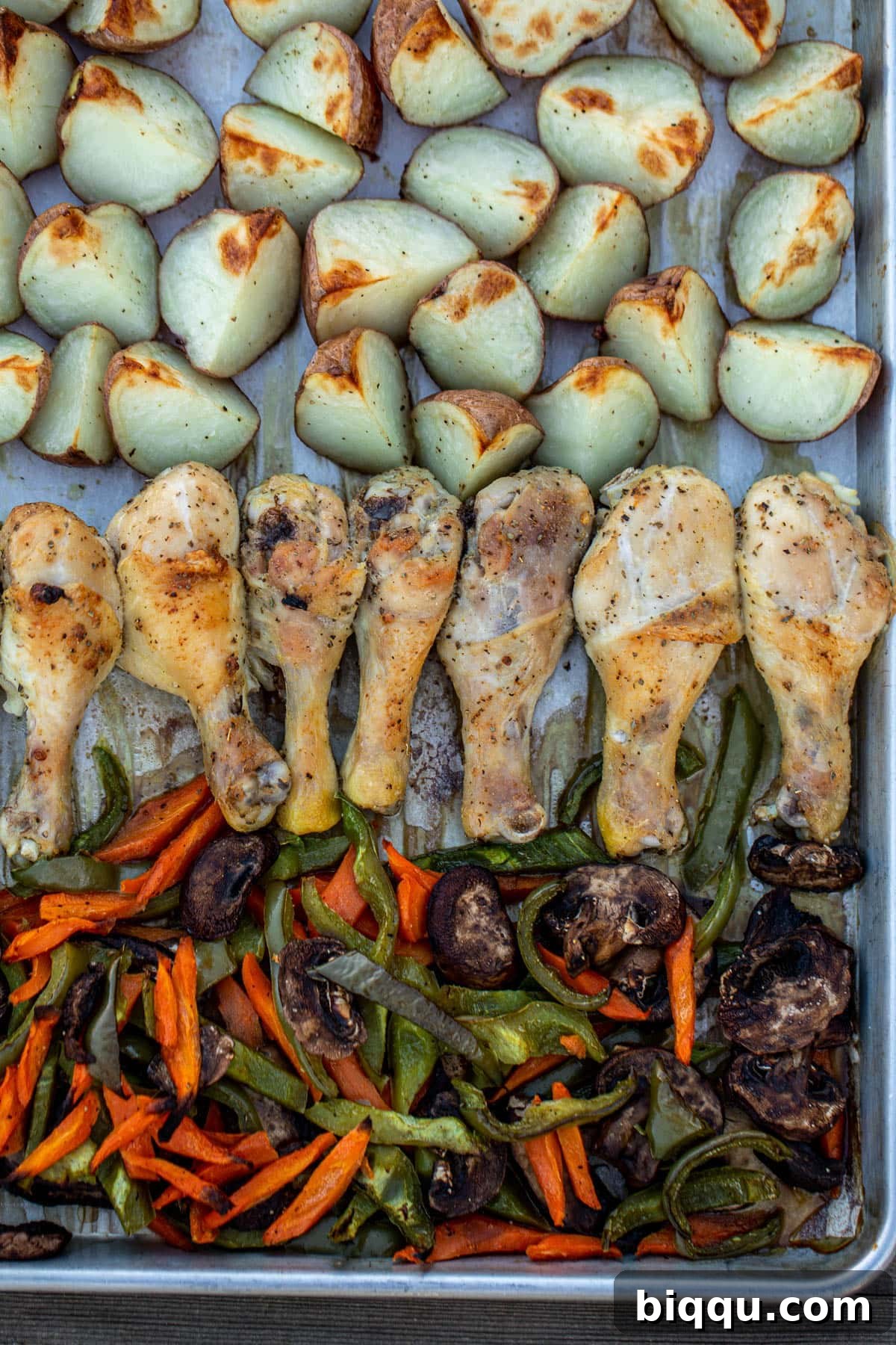 Roasted chicken, potatoes and veggies on a sheet pan, ready to serve