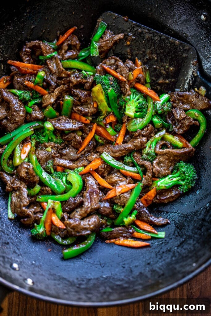 Beef and vegetable stir fry in wok