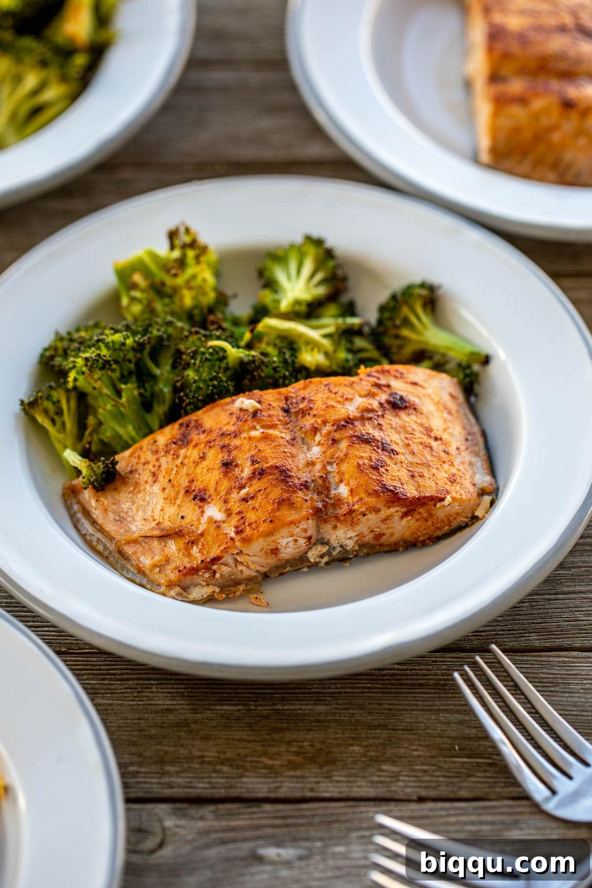 A vibrant plate featuring perfectly cooked salmon and roasted broccoli, garnished and ready to serve
