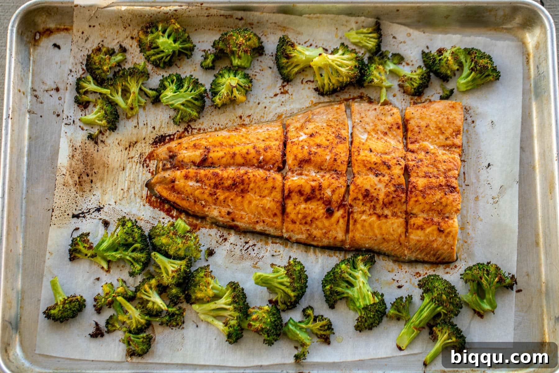 Landscape photo of baked salmon and broccoli fresh out of the oven, golden and perfectly cooked