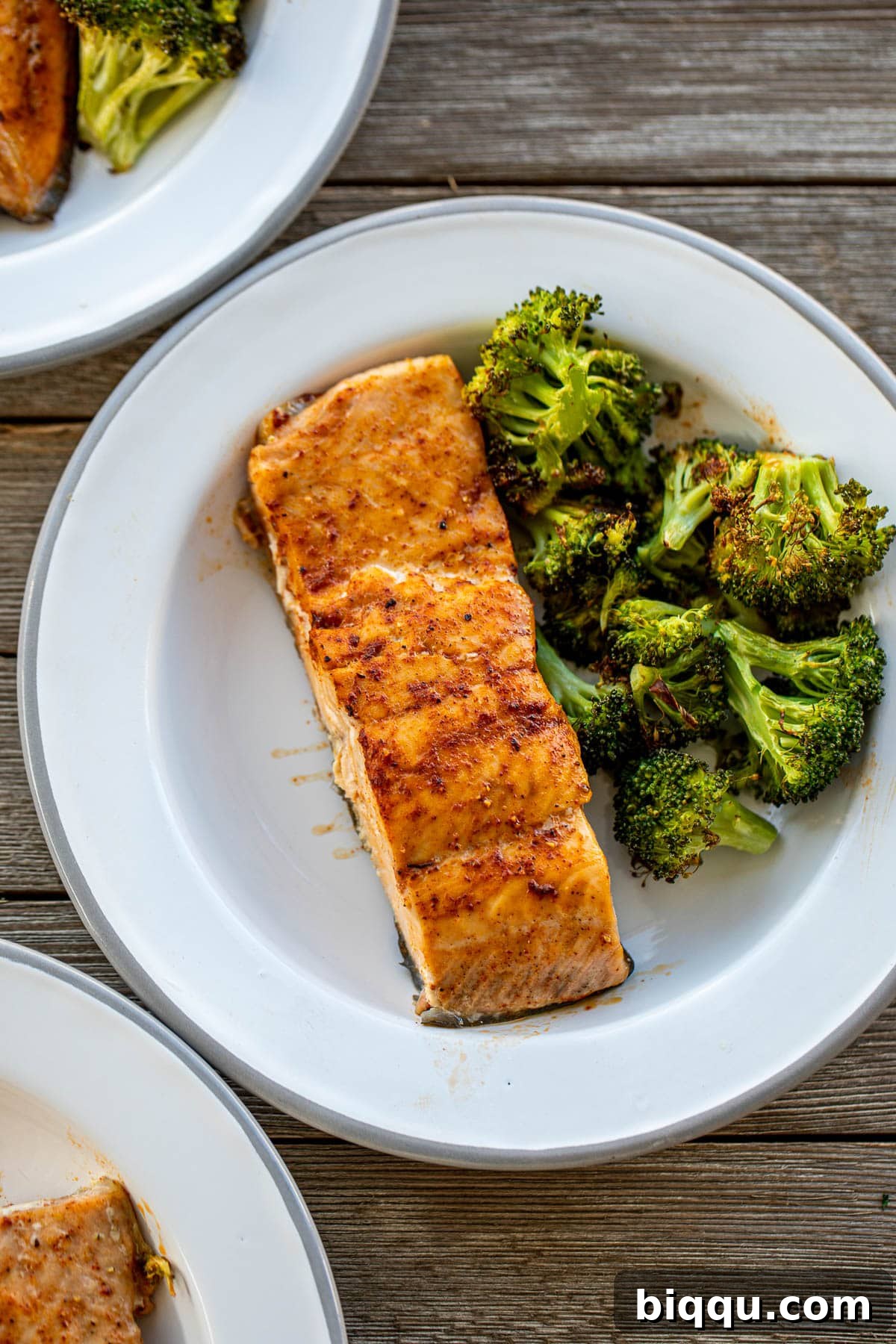 A beautifully plated portion of salmon and broccoli, highlighting the textures and colors