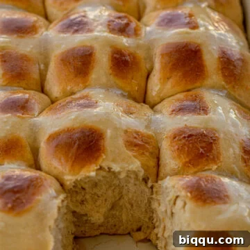 Hot Cross Buns in a baking dish with one removed