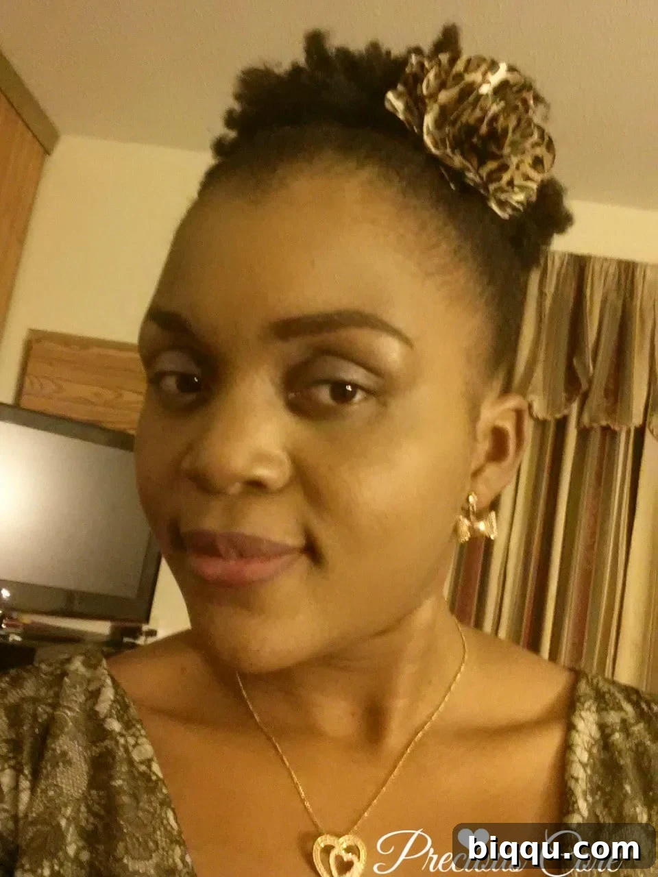 Author with her signature high puff natural hairstyle, edges laid