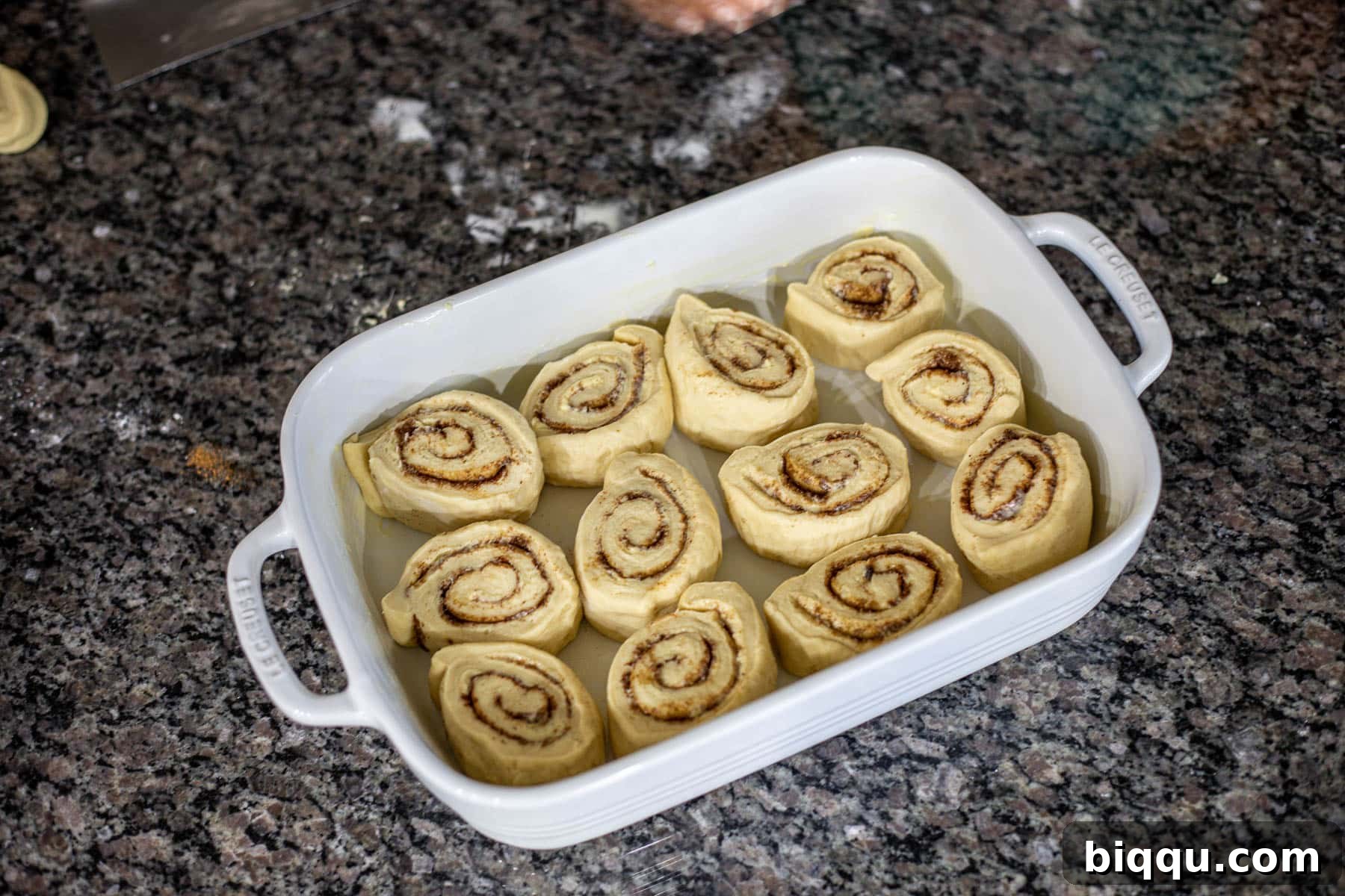 sweet spiced rolls in a white casserole pan