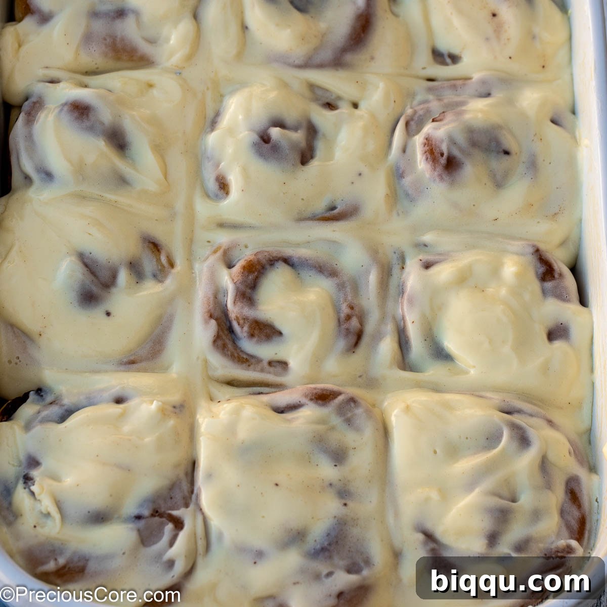 Square image of cinnamon rolls with cream cheese frosting.