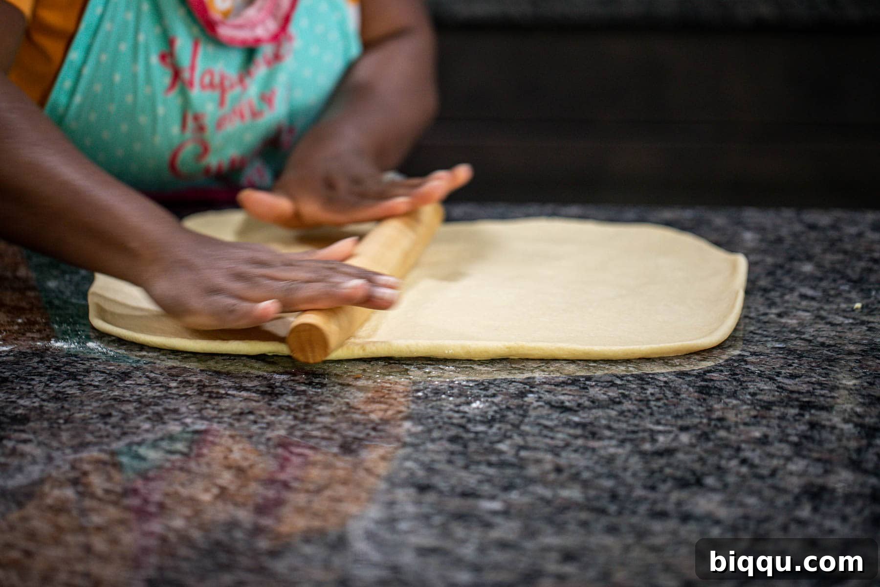 Hand rolling dough into a rectangle.