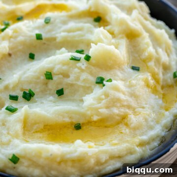 A bowl of buttermilk mashed potatoes, garnished for serving.