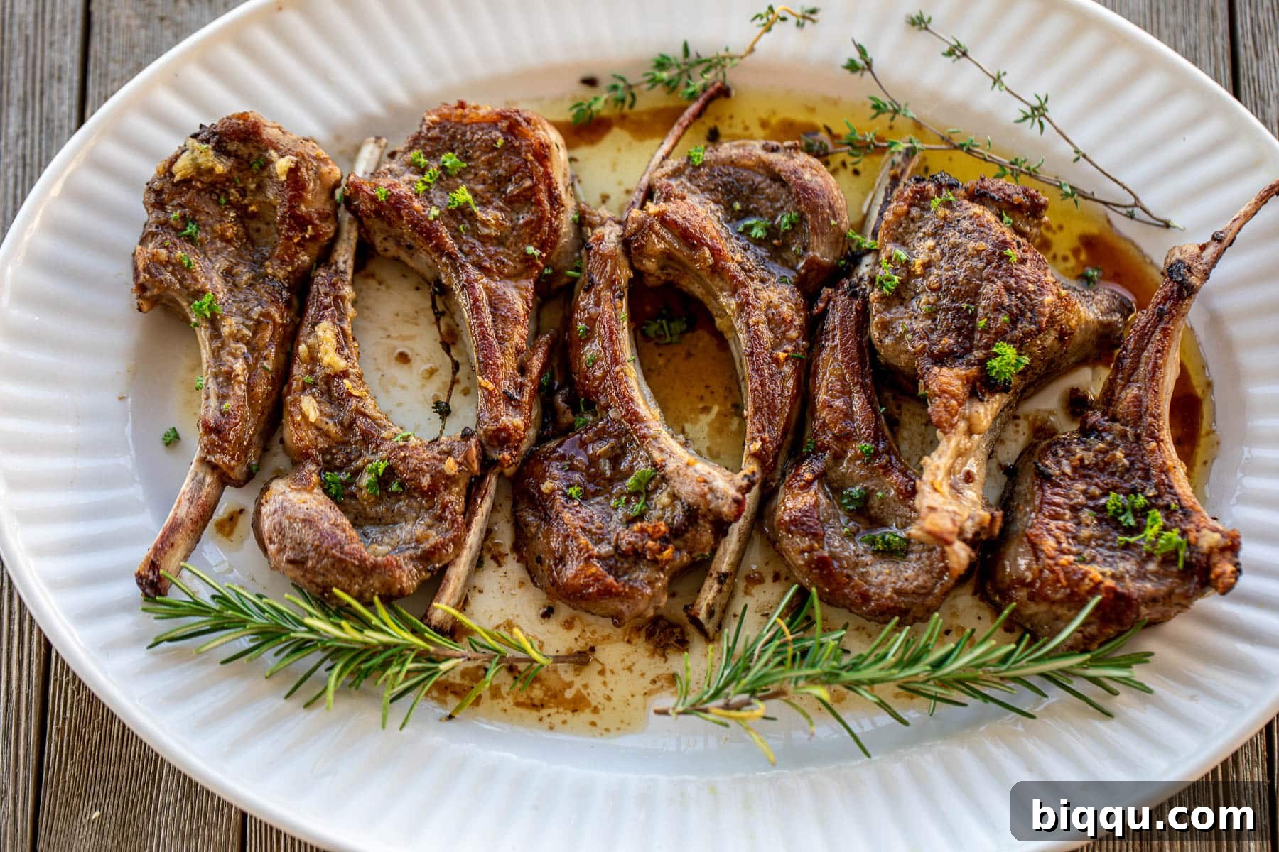 Pan Seared Lamb Chops Garnished with fresh parsley on a serving plate.