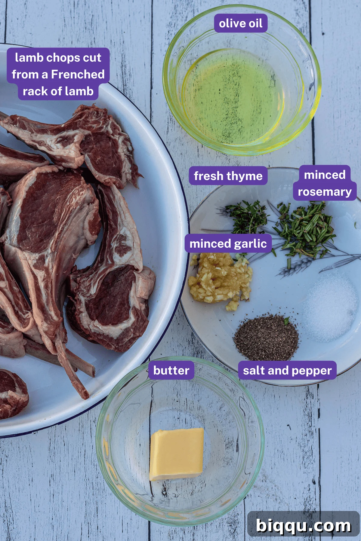 Labeled ingredients for pan seared lamb chops, including fresh herbs, garlic, butter, and lamb.