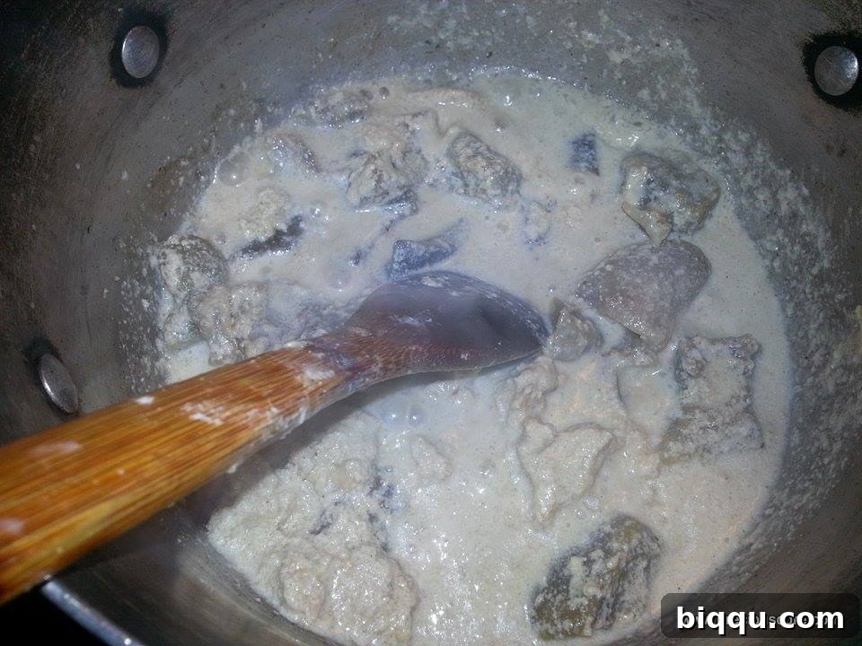 Egusi paste mixed into the boiling stock
