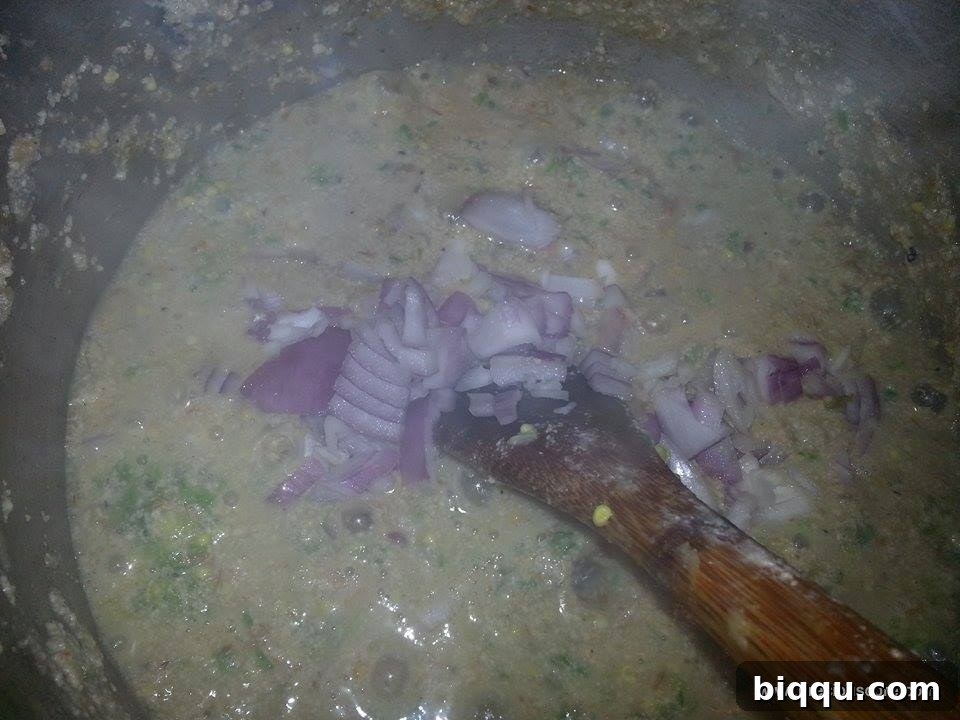 Onions being stirred into the soup