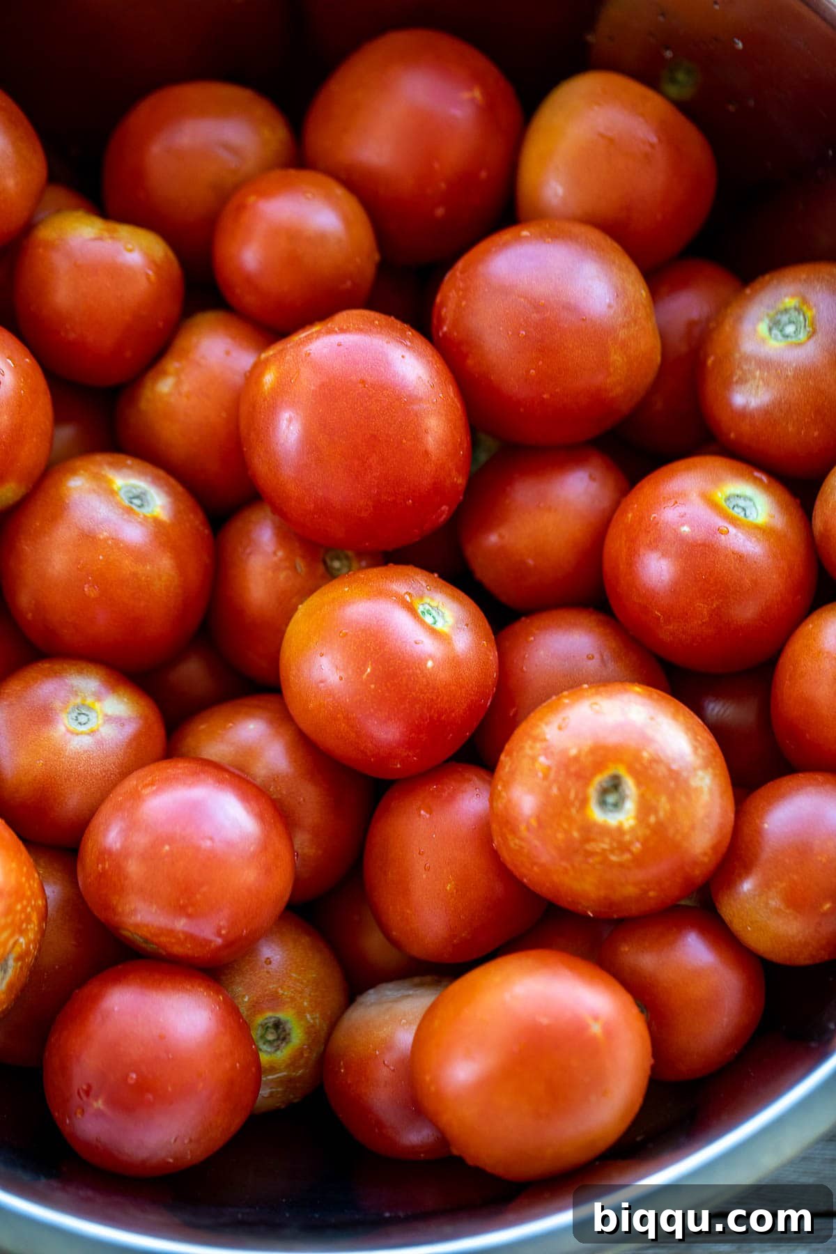 A large pile of fresh, ripe tomatoes, ready for making paste