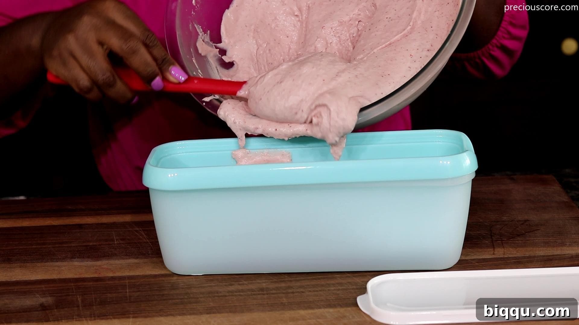 Creamy No-Churn Strawberry Dream 8 The creamy strawberry ice cream mixture being poured into a loaf pan for freezing.