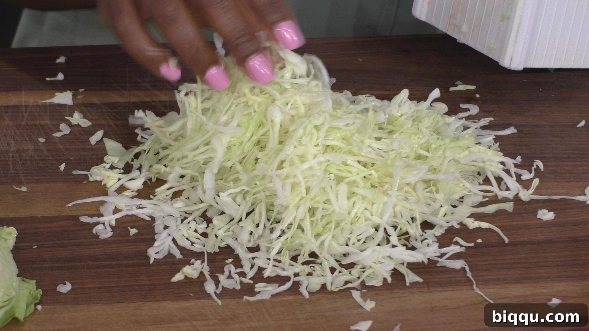 Close-up shot of perfectly shredded cabbage, ready for blanching, illustrating the result of using a box grater.