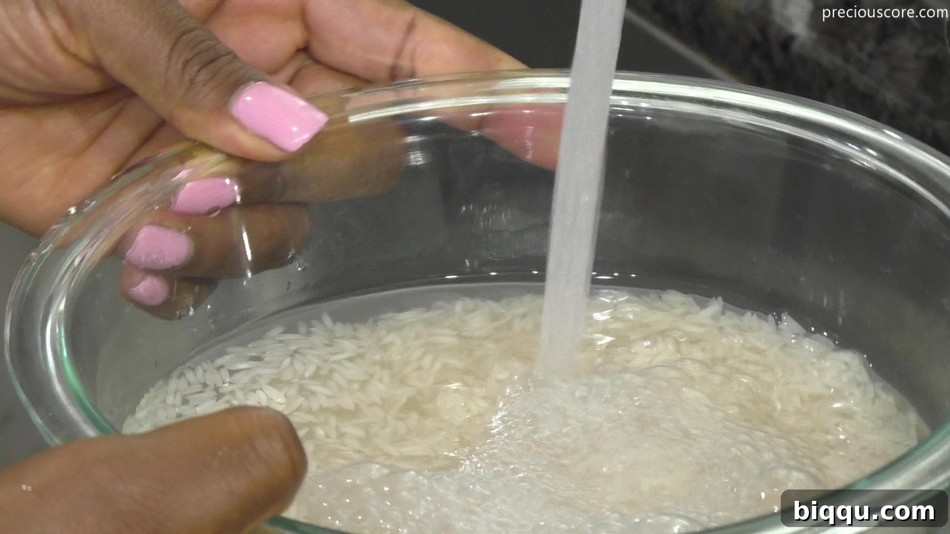 Water being poured over rice in a bowl, illustrating the first step of soaking.