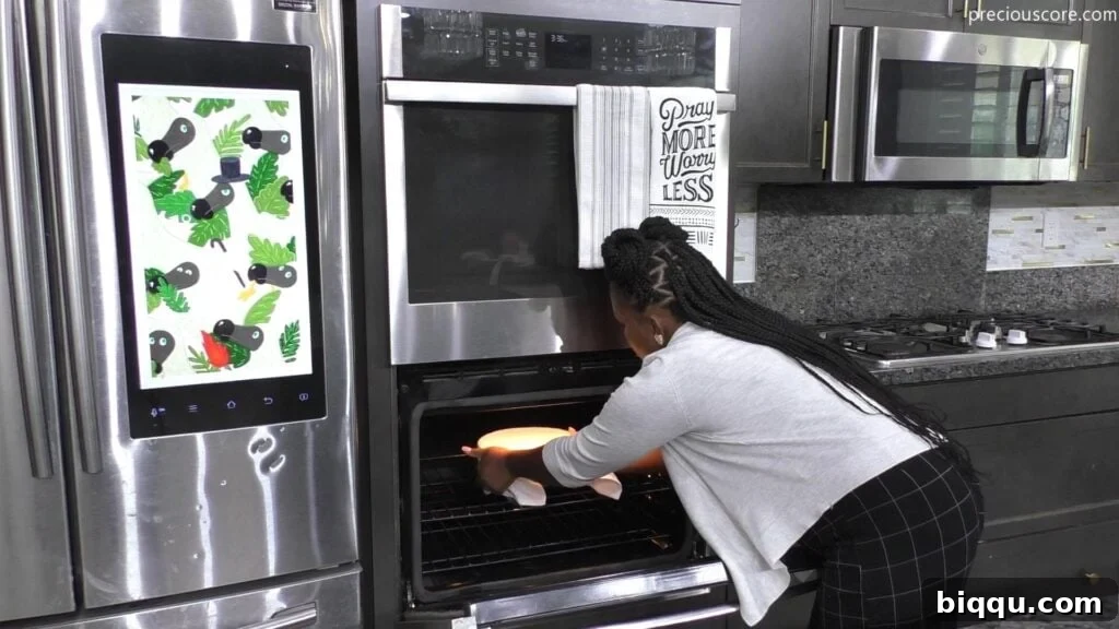 A bowl of rice batter covered with plastic wrap, placed in an oven to rise in a warm environment.