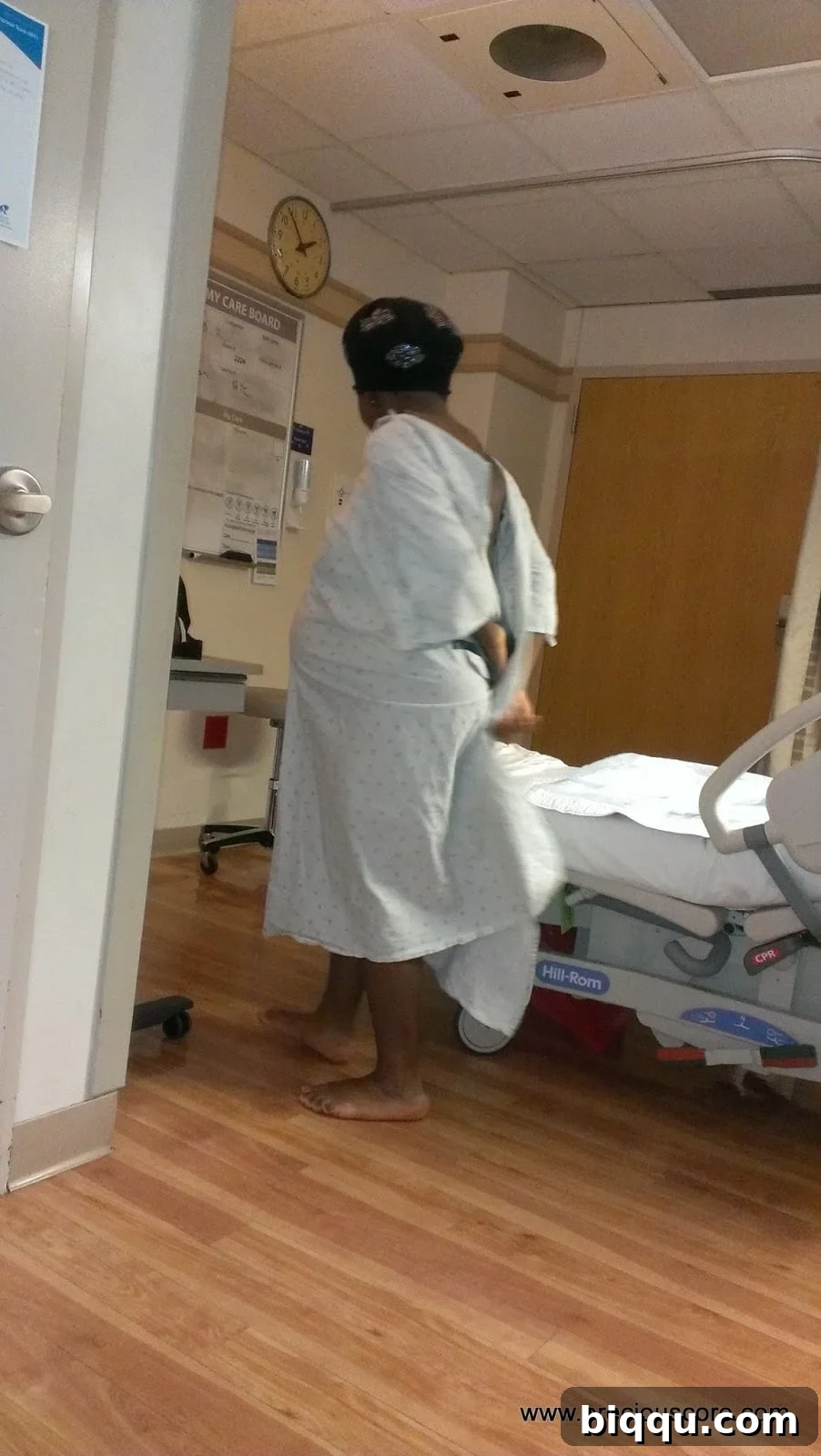 Pregnant woman walking in hospital corridor