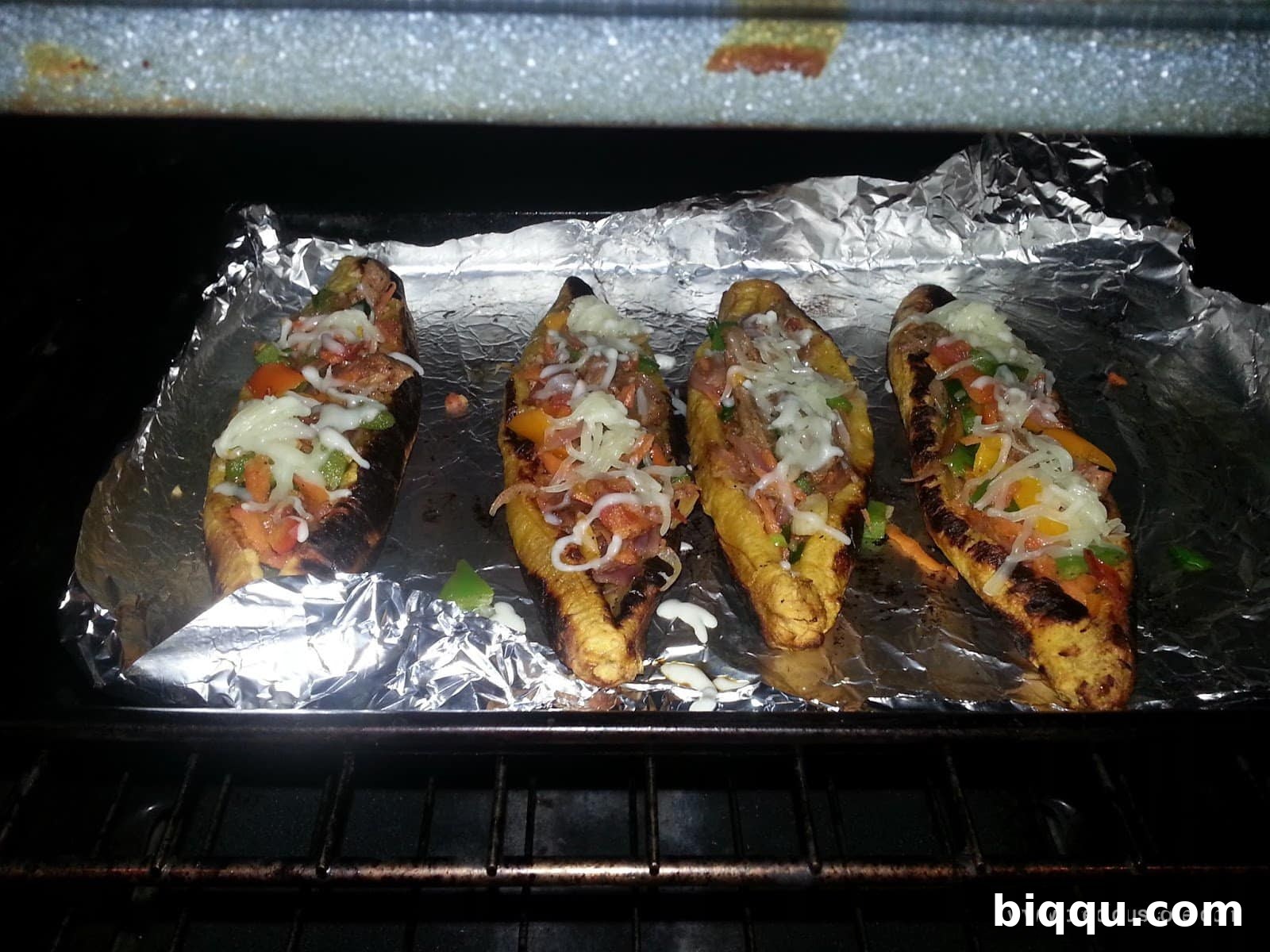 Stuffed plantain boats topped with shredded cheese