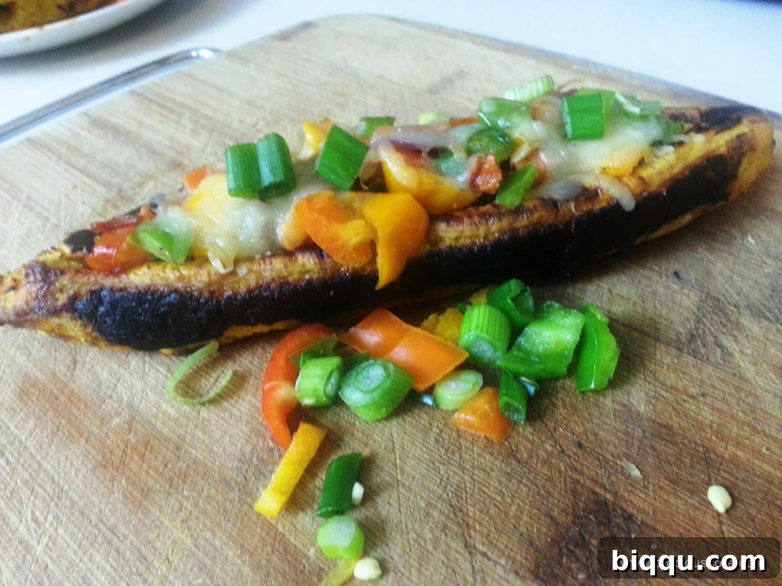 Plantain boats stuffed with meat and vegetables, ready for cheese