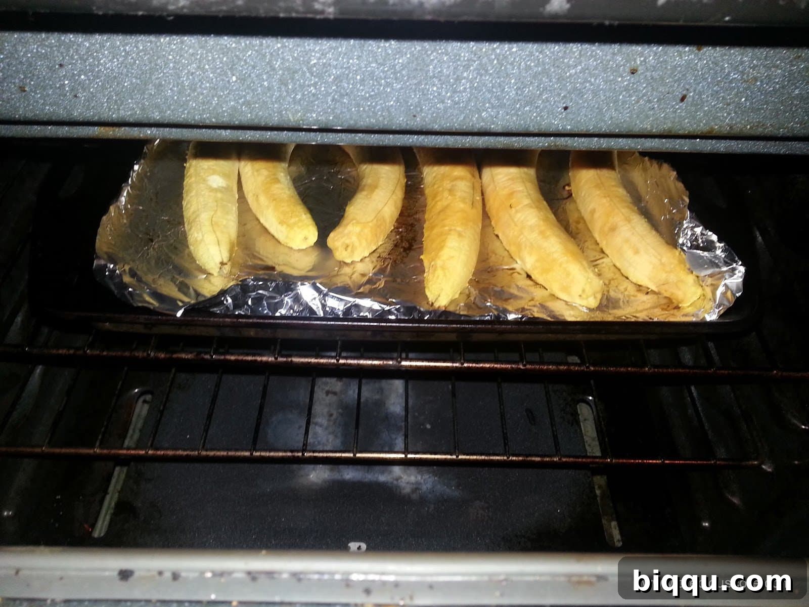Peeled plantains on a baking tray, ready for roasting