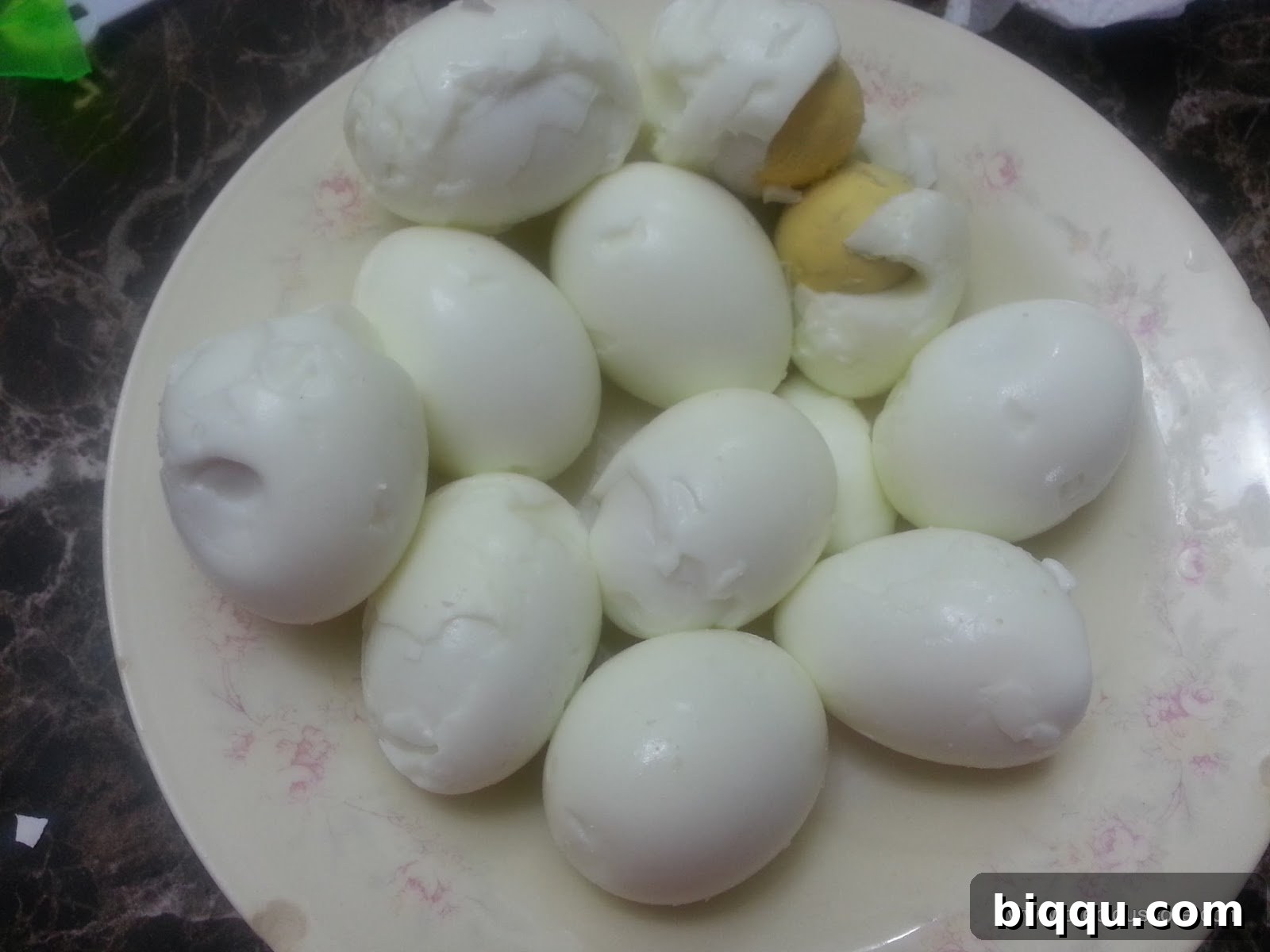 Peeled hard-boiled eggs ready for Scotch Egg preparation, showing smooth surfaces.