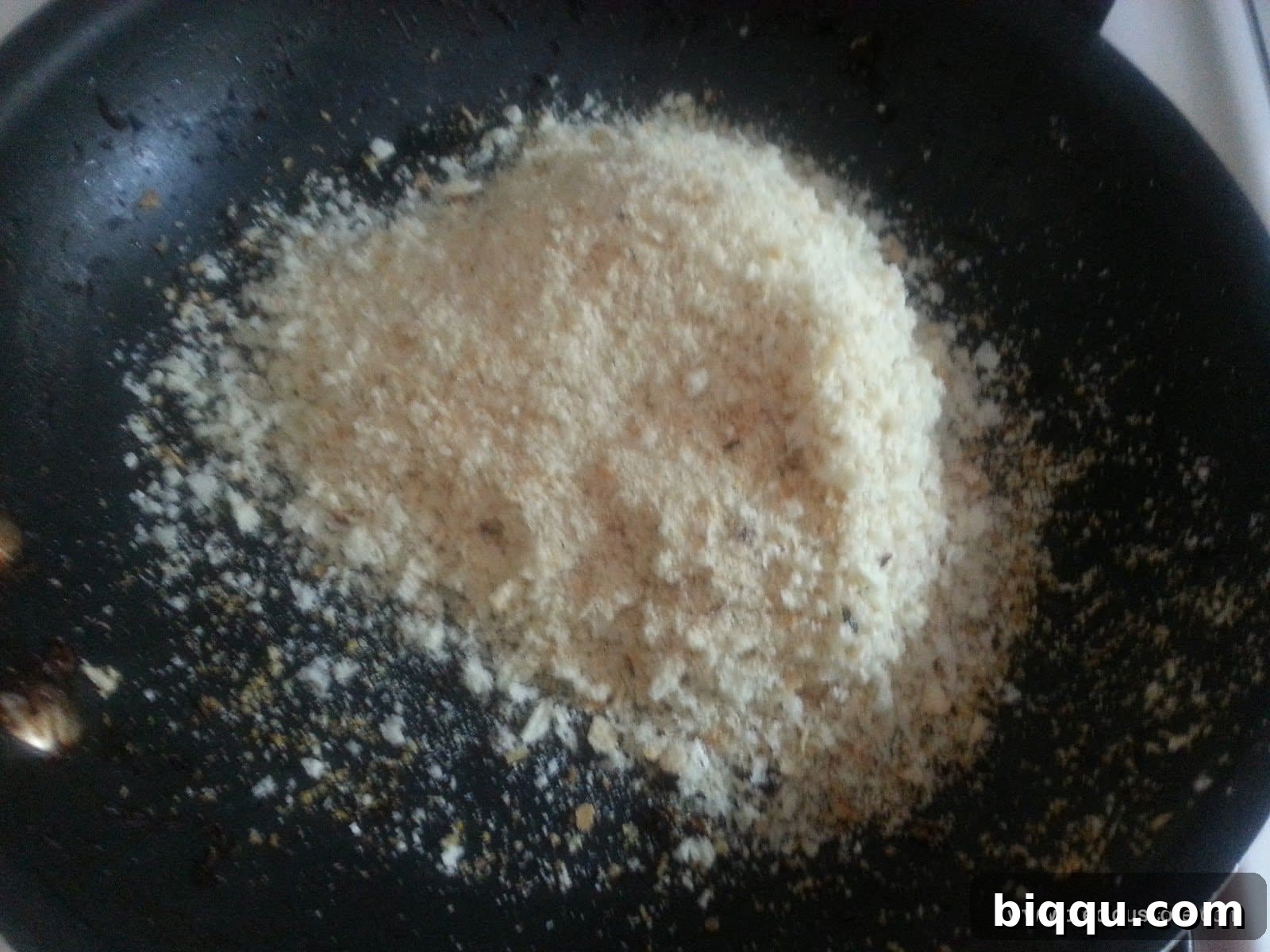 Homemade breadcrumbs, processed from toasted bread, prepared for coating Scotch Eggs. Shows a fine, even texture.