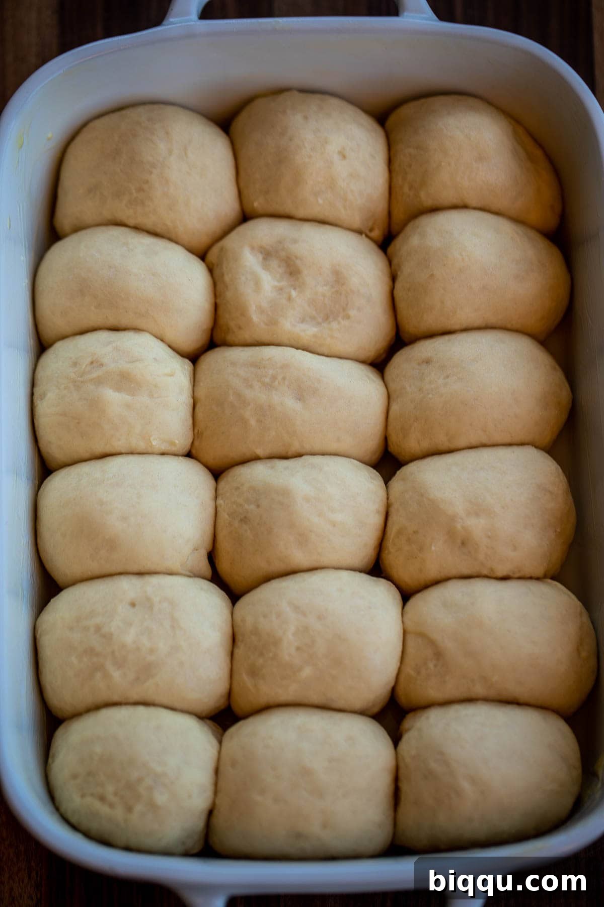 Risen rolls filling the baking dish, showing significant increase in volume.
